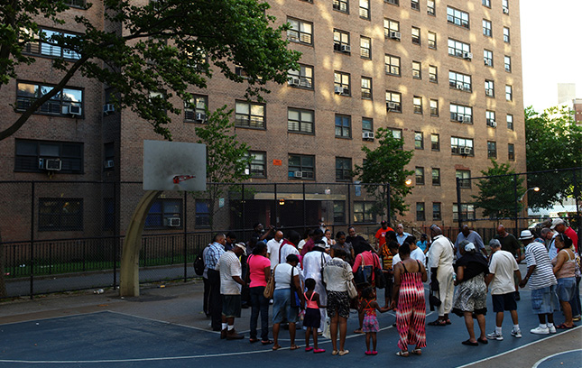 A community gathering outside of a housing development.