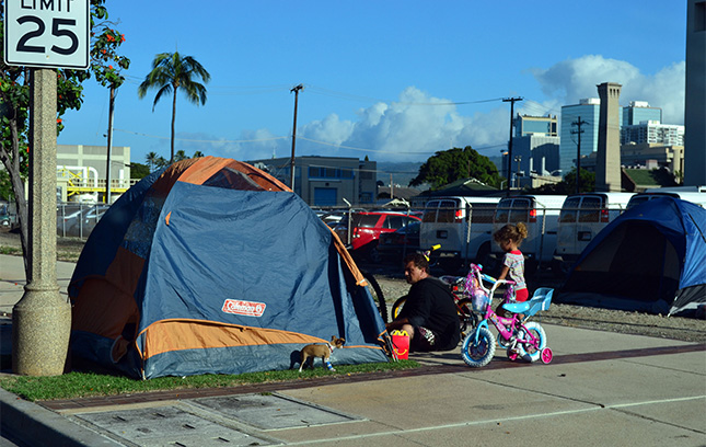 A individual experiencing homeless living in a tent.